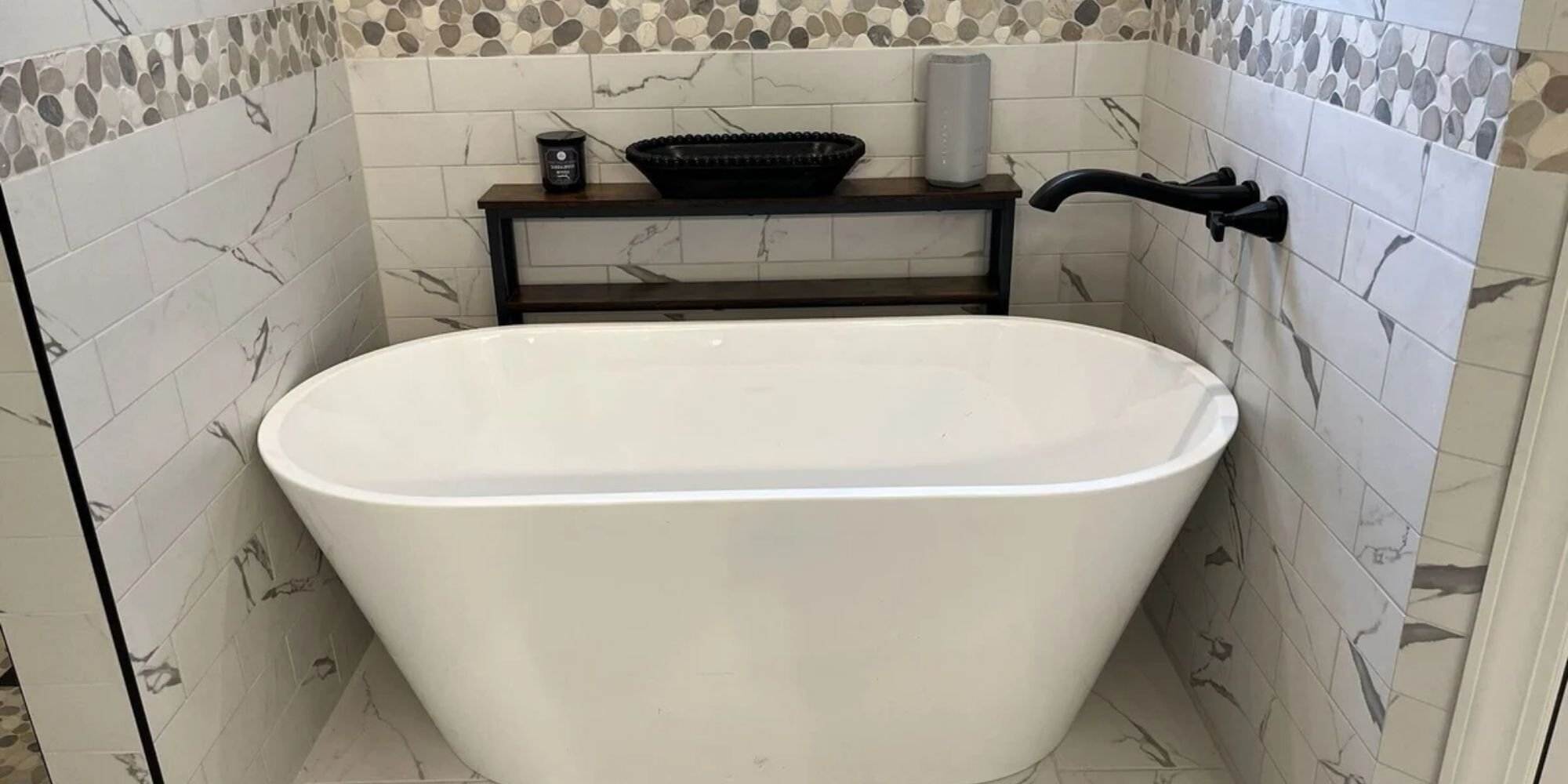 bathroom remodel in Jackson, TN featuring decorative tile and sleek soaking tub by Wolfe Construction