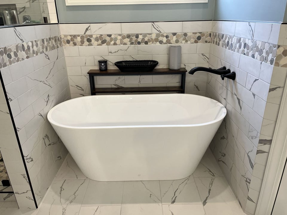 Elegant bathroom renovation showcasing a white freestanding tub and modern fixtures by Wolfe Construction, Jackson, TN