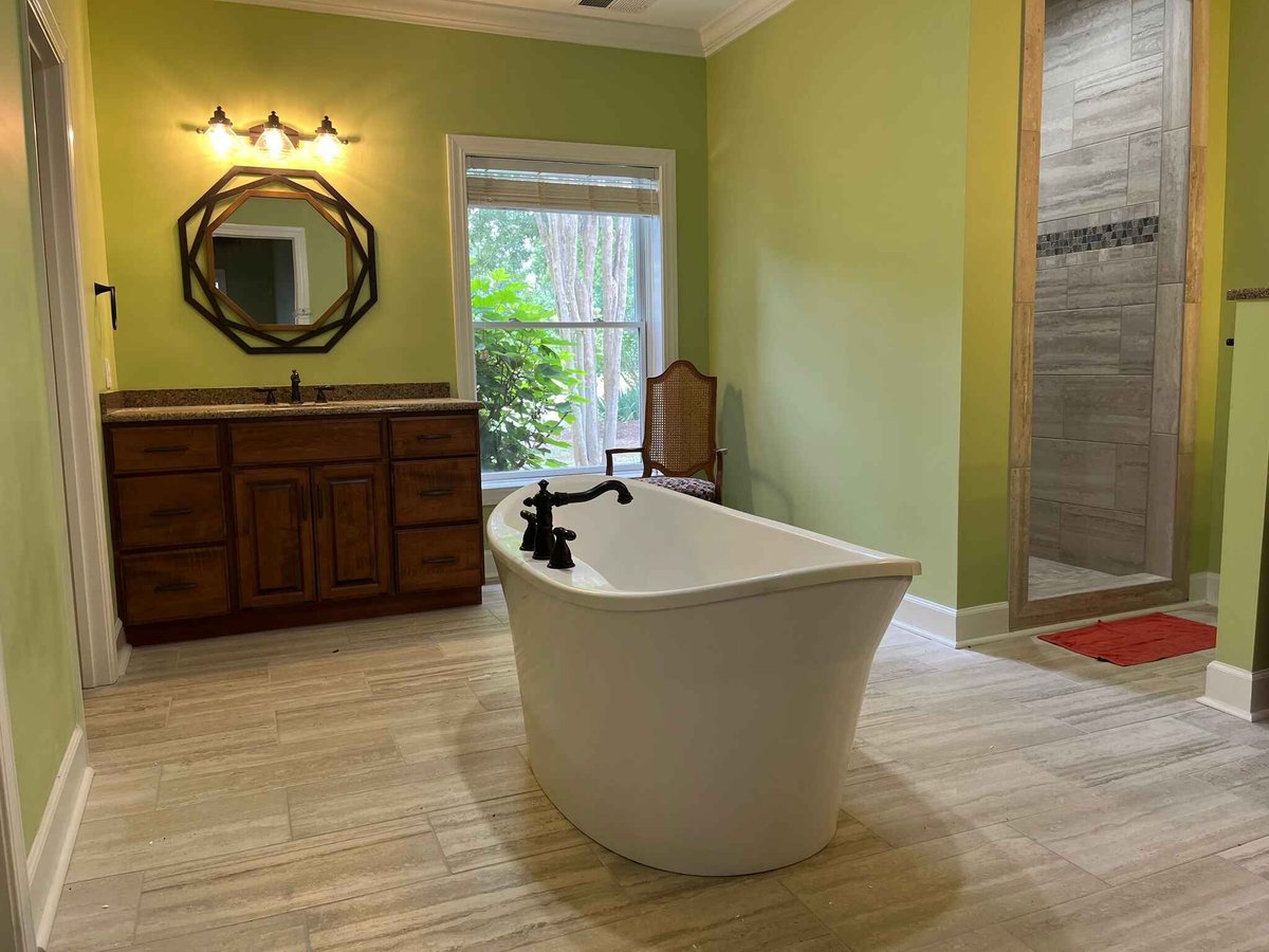 Remodeled bathroom with a standing tub and walk-in shower.