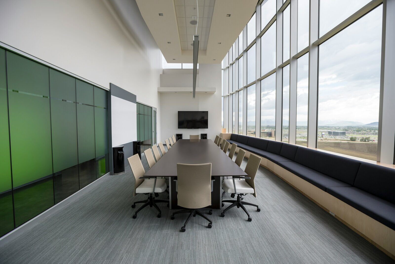 Elegant glass-walled conference room with a long table, remodeled by Wolfe Construction in Jackson, TN Elegant glass-walled conference room with a long table, remodeled by Wolfe Construction in Jackson, TN