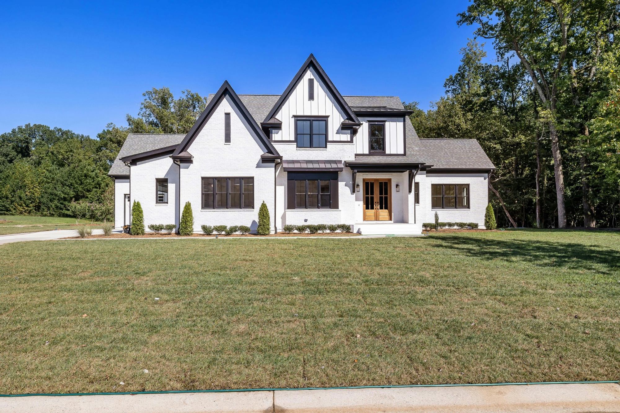 luxury modern farmhouse custom home with white brick exterior and black windows in jackson tn custom homes stock