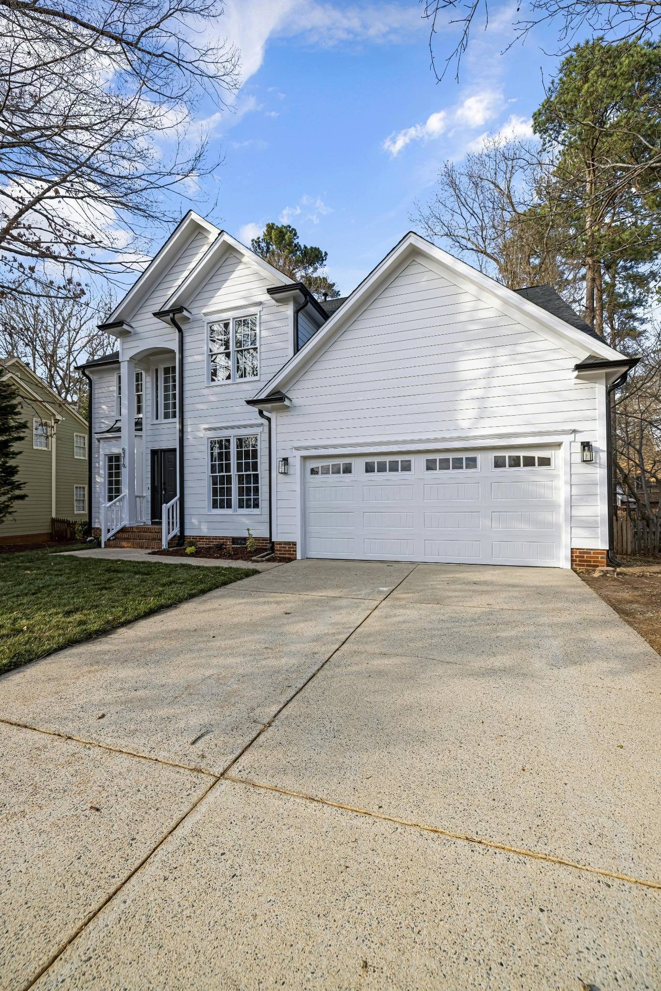 white painted brick custom home with tall front entry and side loaded garage in jackson tn custom homes stock white painted brick custom home with tall front entry and side loaded garage in jackson tn custom homes stock