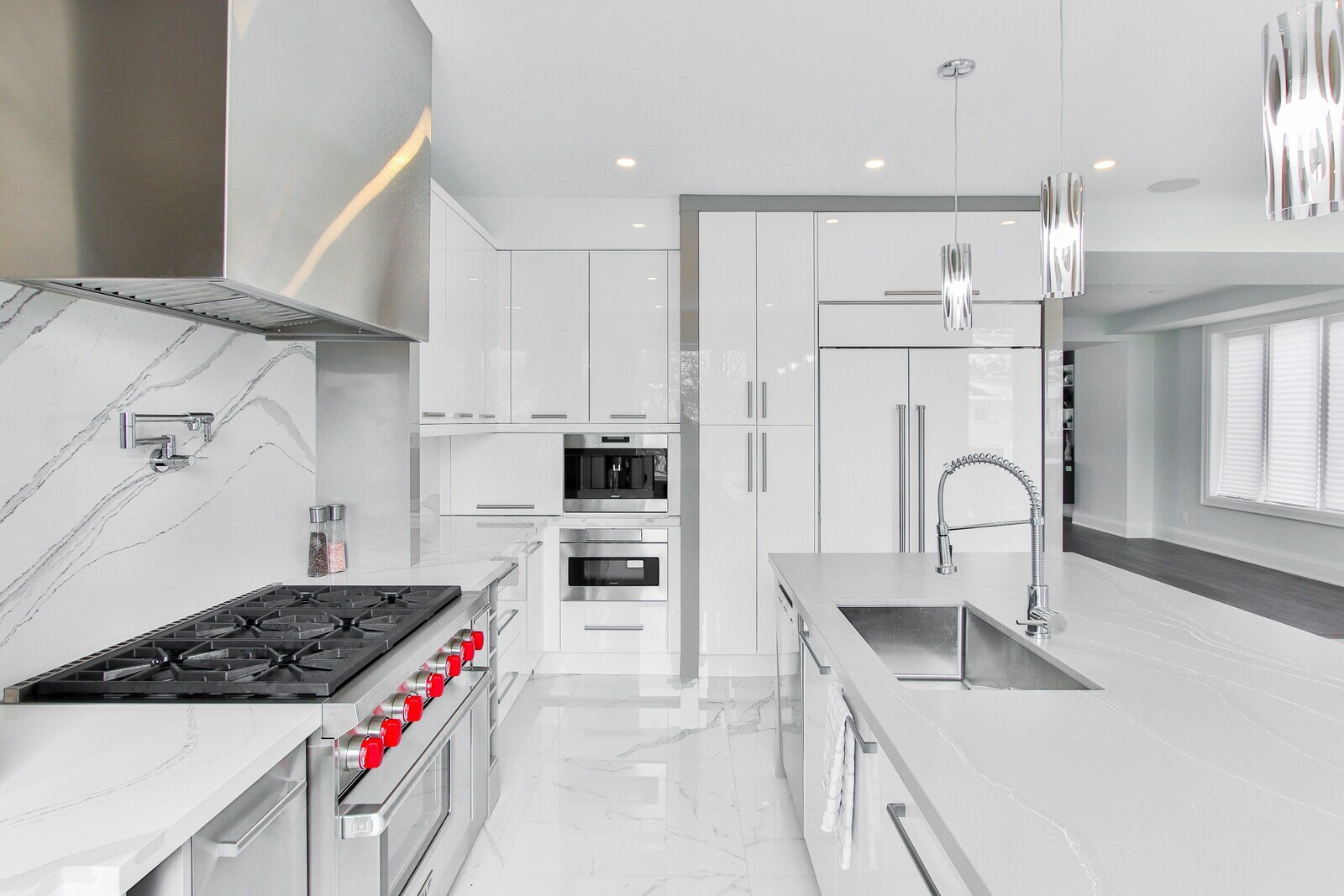 Modern kitchen with white cabinets, marble surfaces, and stainless steel appliances - How Do You Know When It’s Time for a Kitchen Remodel- Wolfe Construction Co - West Tennessee - Home Builder & Remodeler