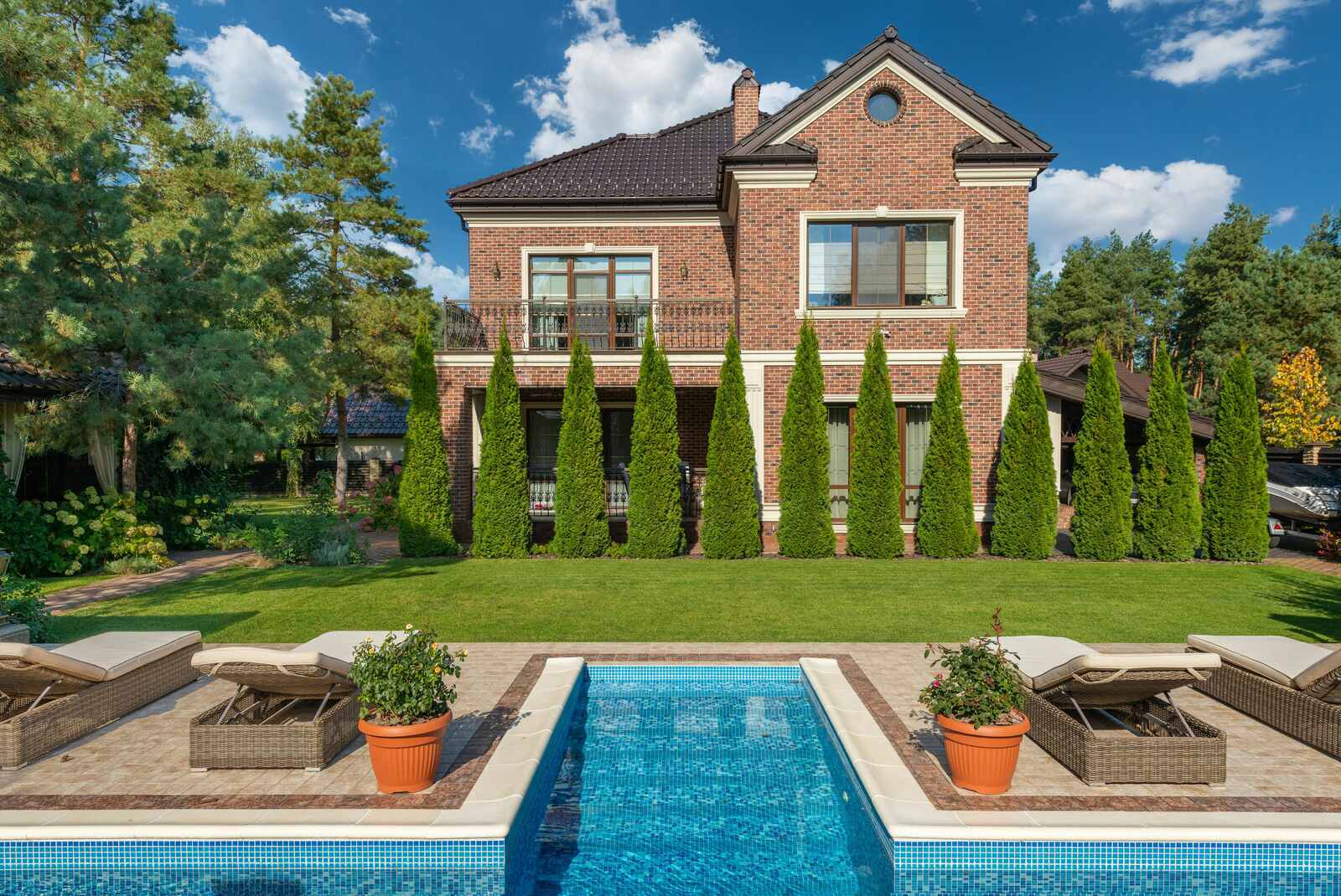 Elegant brick custom home with a pool and landscaped garden - The Home Remodeling Process & Timeline - Wolfe Construction Co - West Tennessee - Home Builder & Remodeler
