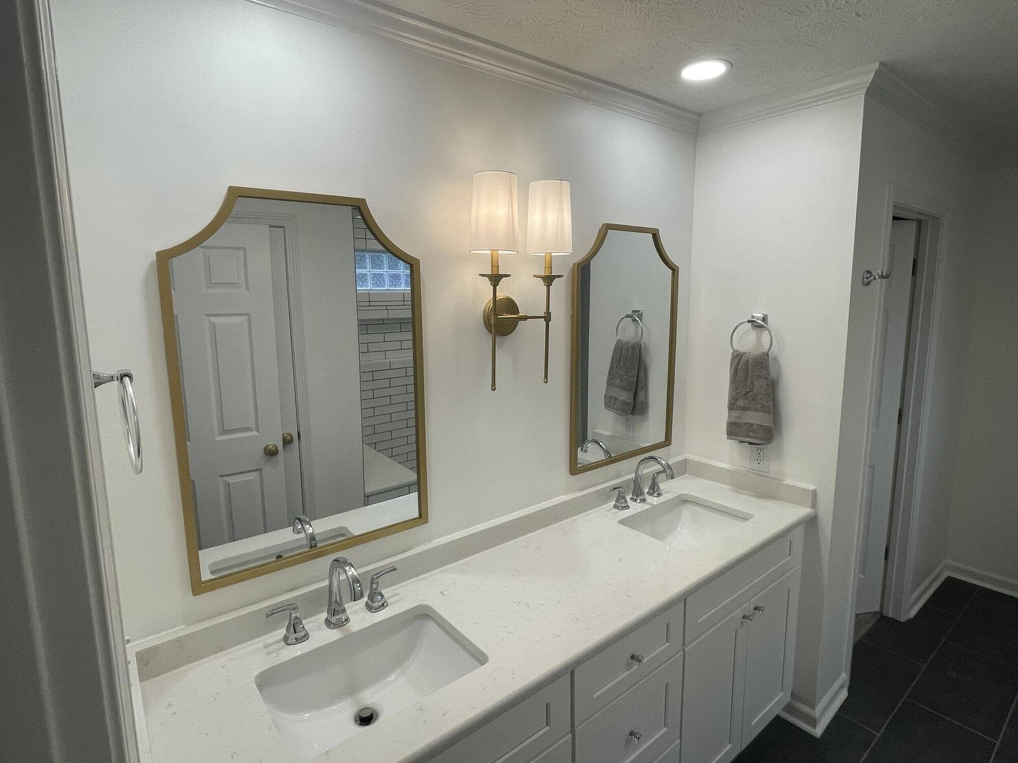 West Tennessee-Remodeling Company- Wolfe Construction Co.-Elegant double vanity bathroom with gold-framed mirrors by Wolfe Construction in Jackson, TN