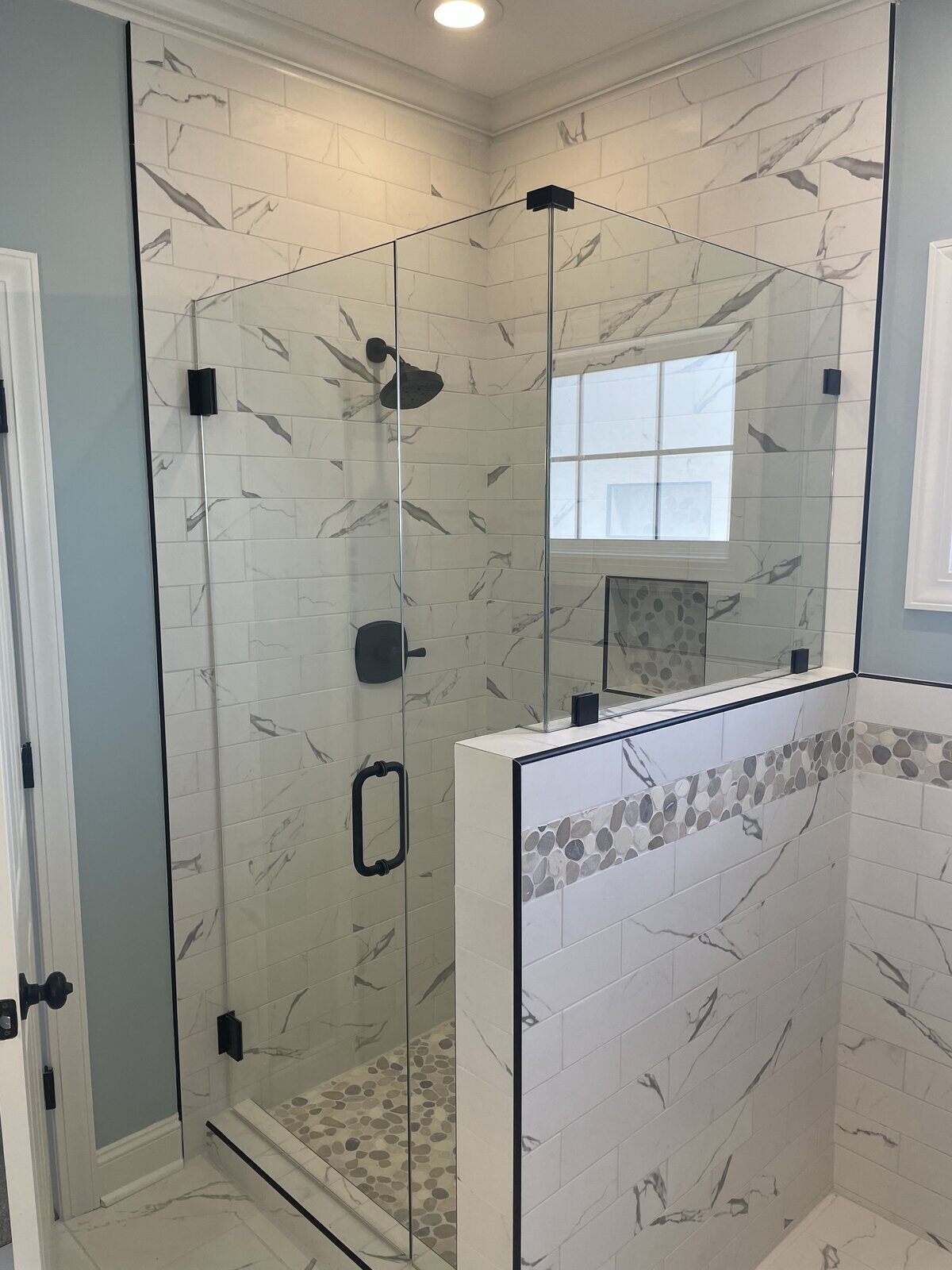 Luxurious bathroom renovation featuring a modern shower with black hardware by Wolfe Construction, Jackson, TN