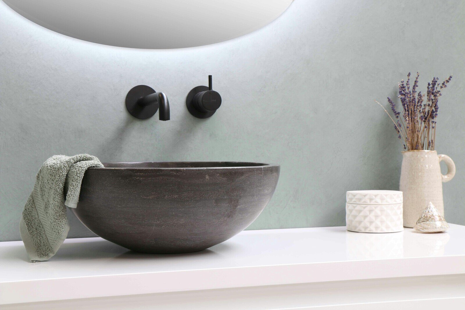 Minimalist bathroom remodel with a stone vessel sink and modern matte black fixtures by Wolfe Construction, Jackson, TN