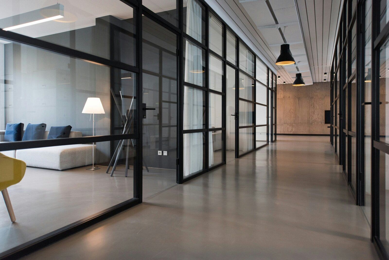 West Tennessee-Commercial Renovation Services- Wolfe Construction Co.-Modern office hallway with glass partitions after commercial renovation by Wolfe Construction in Jackson, TN