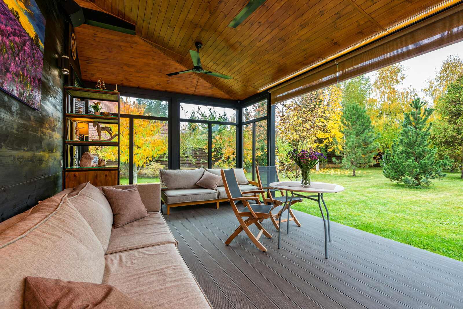 West Tennessee-Custom-Outdoor-Living-Space-Construction- Wolfe Construction Co.-Cozy outdoor living area with wooden ceilings and scenic backyard, part of a Wolfe Construction project in Jackson, TN